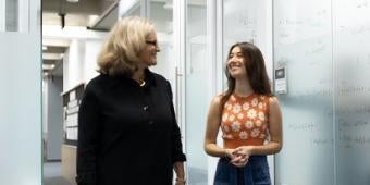 Cohen Fellow and faculty member in hallway