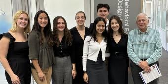 Students and Harvey S. Cohen in hallway